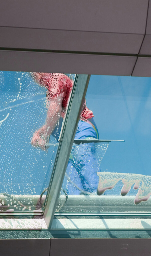 Man Cleaning windows from the outside