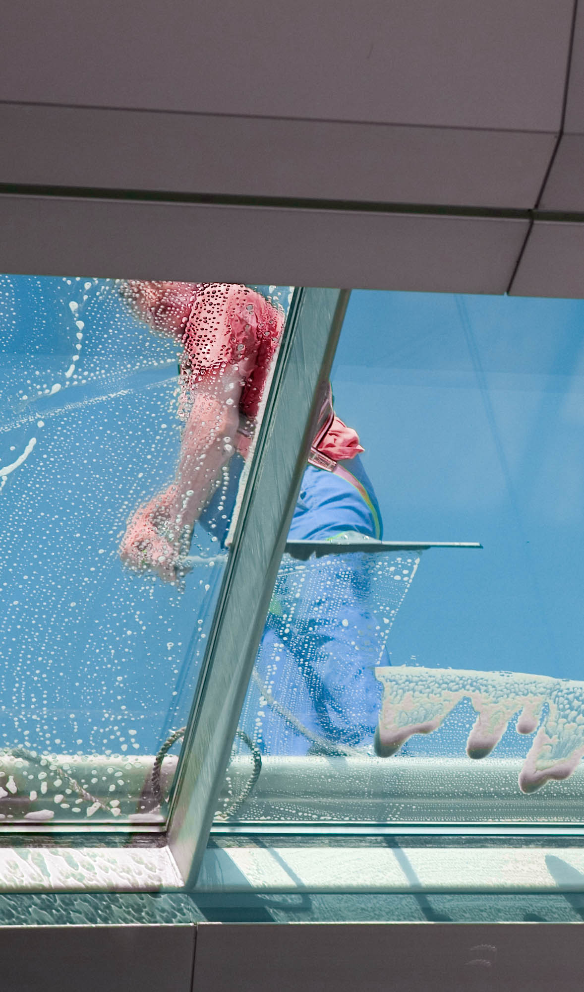 Man Cleaning windows from the outside